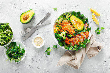 Buddha bowl with grilled chicken breast, avocado and fresh vegetable salad for lunch