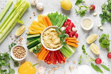 Hummus with fresh vegetables, healthy vegetarian food concept, top view