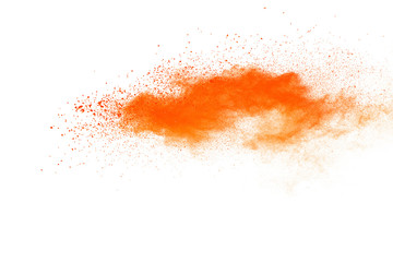 Abstract orange powder explosion. Closeup of orange dust particle splash isolated on white background