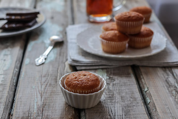 muffins with chocolate on an old rustic table