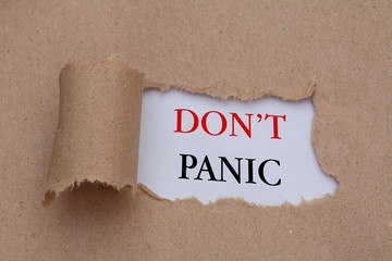 Don't panic text concept,torn brown paper