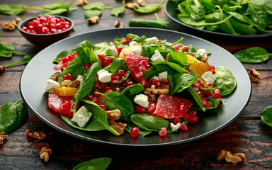 Orange Grapefruit salad with spinach, walnuts, pomegranate seeds and feta cheese. healthy food