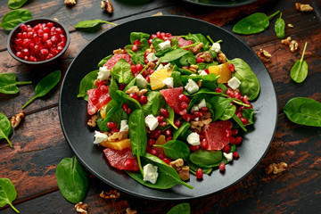 Orange Grapefruit salad with spinach, walnuts, pomegranate seeds and feta cheese. healthy food