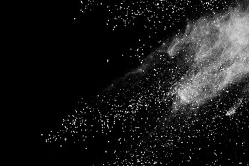 White powder explosion isolated on black background.