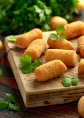 Homemade Potato Croquettes with dipping sauce on wooden board