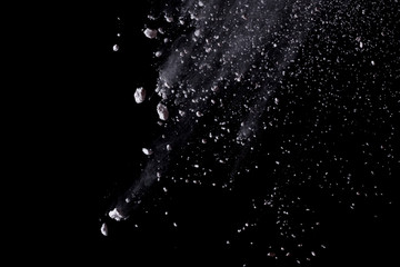 White powder explosion isolated on black background.