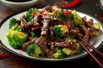Homemade Beef and Broccoli with Rice and herbs on wooden table