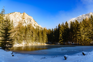 Peaceful mountain view with Pfarrerteich lake in Austria Styria. Tourist destination lake Gruner See in winter. Travel spot situated in Tragos in lime stone Alps of Hochschwab.