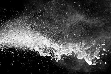 White powder explosion isolated on black background.