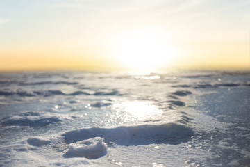 frozen river in a snow at the sunset, winter background