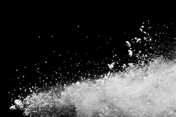 White powder explosion isolated on black background.