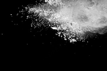 Fototapeta na wymiar White powder explosion isolated on black background.