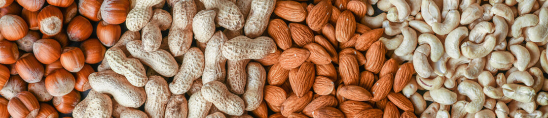 Mix nut wide banner or panorama. Natural healthy food background made from different kinds of nuts.