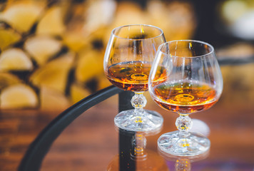 Close-up of two glasses of alcohol drink. Blurred background.
