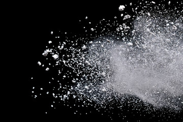 White powder explosion isolated on black background.