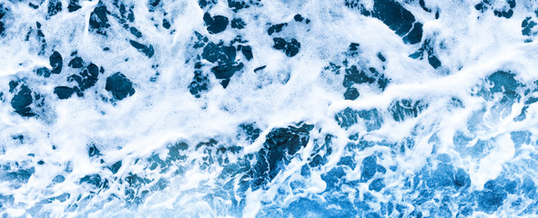 Aerial view of salt ocean foam and waves. Blue water aqua sea background ot texture. Rippled...