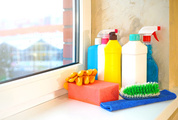 Cleaning service. Household chemicals standing on the office window.