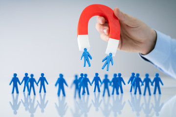 Businessperson Attracting Human Figures With Horseshoe Magnet