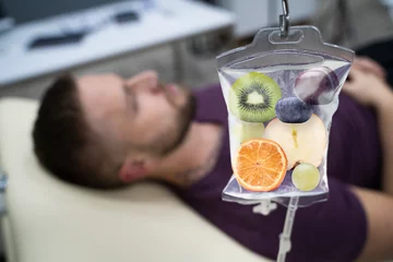 Fotobehang Fruit Slices Inside Saline Bag Hanging In Hospital © Andrey Popov