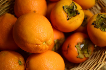 Orange fruits close-up. Oranges, tangerines and persimmons.