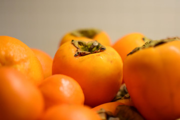 Orange fruits close-up. Oranges, tangerines and persimmons.