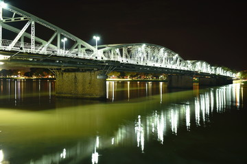 Fototapeta na wymiar bridge cross river and reflection light bulb on night in Vietnam