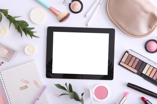 cosmetics and modern tablet on a colored background top view. Beauty blog concept.