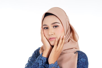 A beautiful female Muslim model wearing dark blue modern kurung with hijab, a modern urban lifestyle apparel for Muslim women isolated on white background. Beauty and hijab fashion concept.