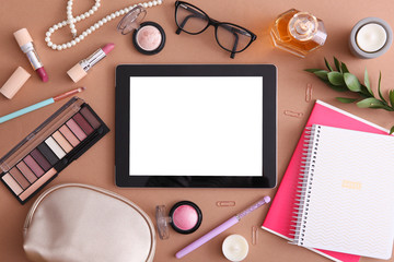 cosmetics and modern tablet on a colored background top view. Beauty blog concept.