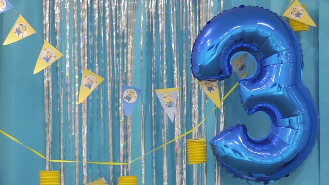 Three years birthday balloon on children minions style happy birthday party yellow blue colors design decorations background