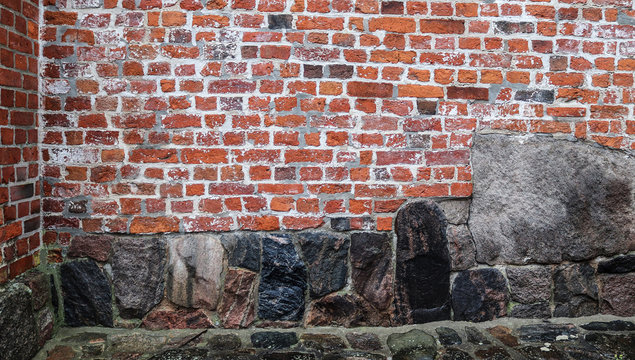 Detailed close up view on aged and weathered red brick walls in high resolution
