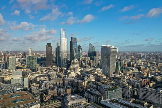 London city centre aerial panorama view: financial district, Thames river, Belfast, skyscrappers, warf and buildings and St. Pauls Cathedral, Tower Bridge and The Tower