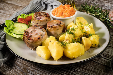Pork tenderloin wrapped in bacon.