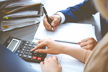 Bookkeeper or financial inspector and secretary making report, calculating or checking balance....
