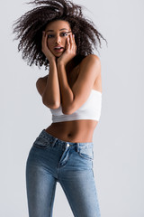african american woman in white top isolated on grey
