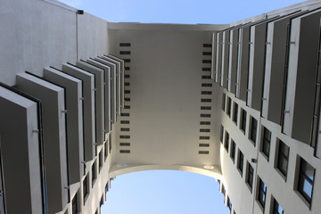 Arch in a modern white high-rise building. Top to bottom view. Vanguard, abstract.