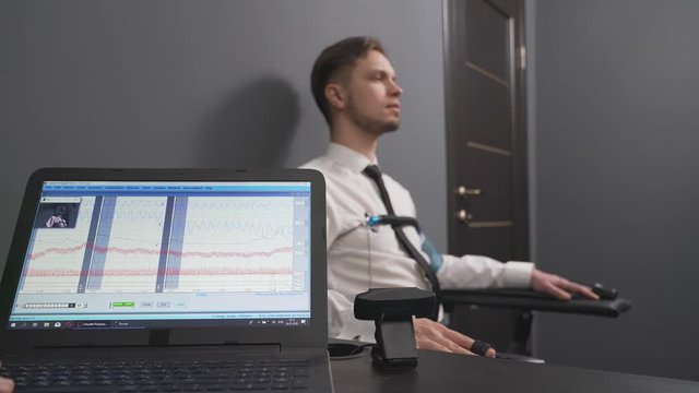 Handsome guy answering questions during polygraph test