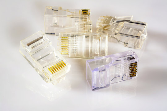 Connector rj-45. Five transparent connectors rj45 for cable for network and internet. Close-up macro on gloss white background with shadow.