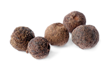 Spicy black pepper grains isolated on white