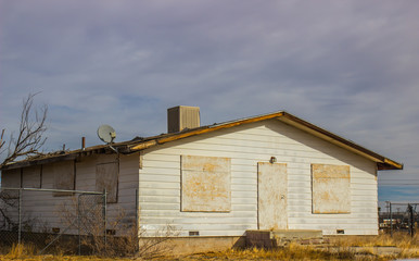 Boarded Up Windows & Door On Abandoned House