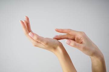 Spa and Manicure concept. Beautiful hands of a young girl with beautiful manicure on a gray...