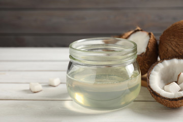 Coconut oil on white wooden table, closeup