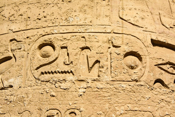 Karnak temple complex in Luxor, Egypt. Ancient bas relief with hieroglyphs on column.