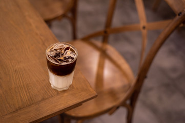 iced coffee put on wooden table in mini cafe