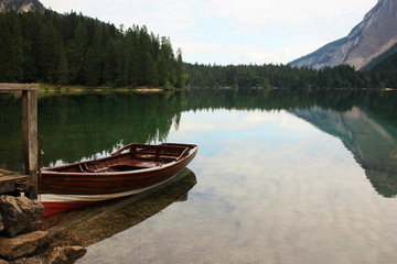 Wooden boat at the pier on the lake