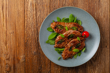 Saltimbocca. Veal schnitzel with sage and Parma ham. Italian specialty. Top view.