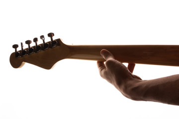 man playing the guitar holding the fretboard