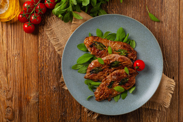 Saltimbocca. Veal schnitzel with sage and Parma ham. Italian specialty. Top view.