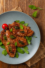 Saltimbocca. Veal schnitzel with sage and Parma ham. Italian specialty. Top view.