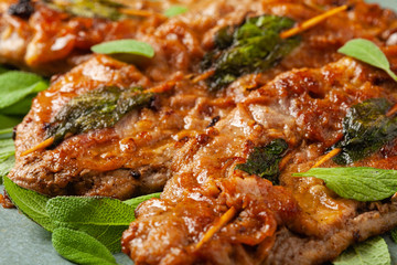 Saltimbocca. Veal schnitzel with sage and Parma ham. Italian specialty. Front view. Close up.